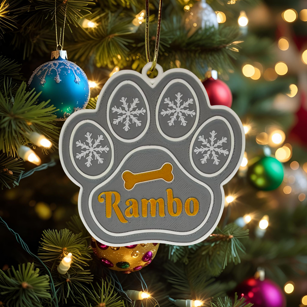 Paw-shaped ornament with 'Rambo' on a Christmas tree
